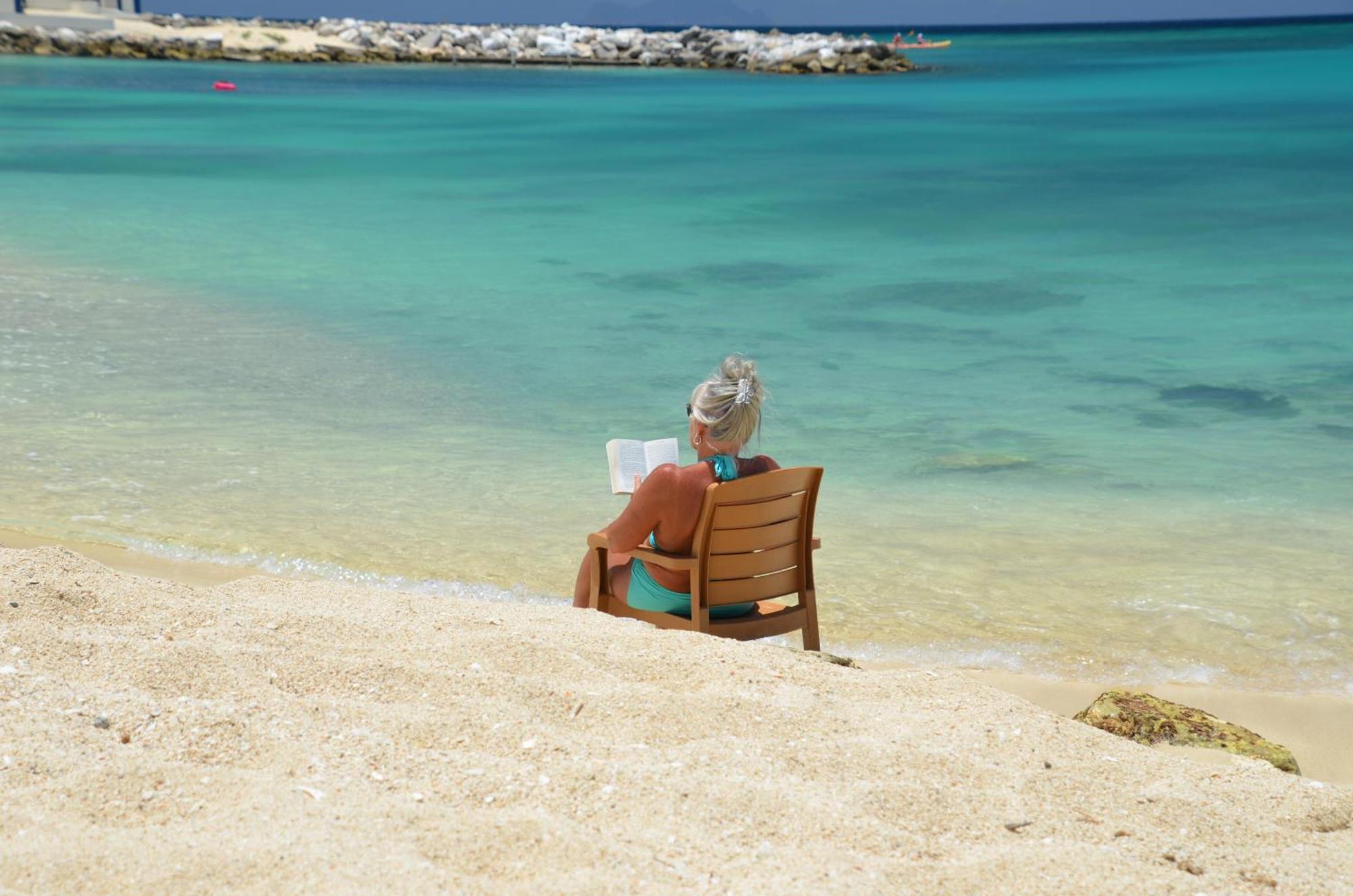Simpson Bay Resort Marina & Spa Exterior photo A woman reading on a beach
